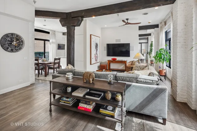 a work room with furniture a flat screen tv and a window