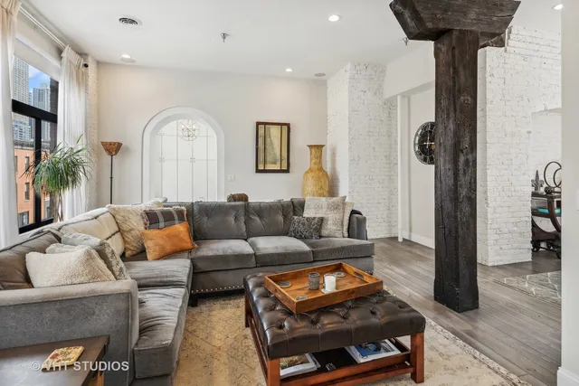 a living room with furniture a rug and a chandelier