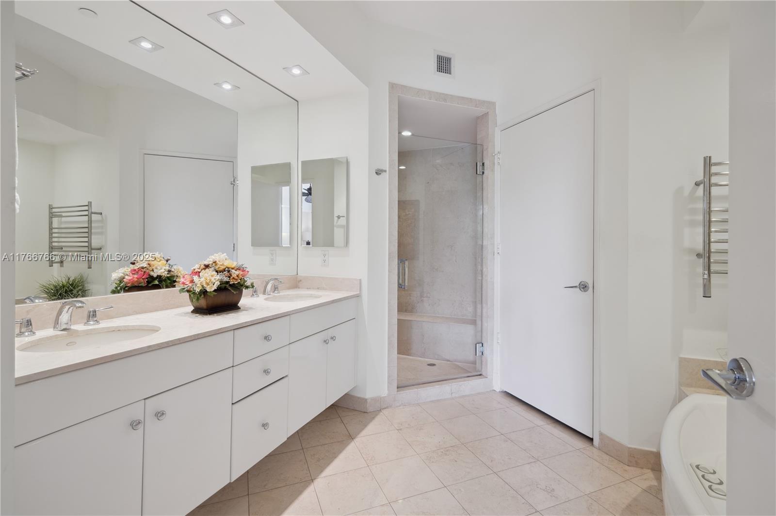 765 Crandon Boulevard, Unit 111 Key Biscayne, FL 33149 - Photo 15 of 57 a bathroom with a sink double vanity and shower