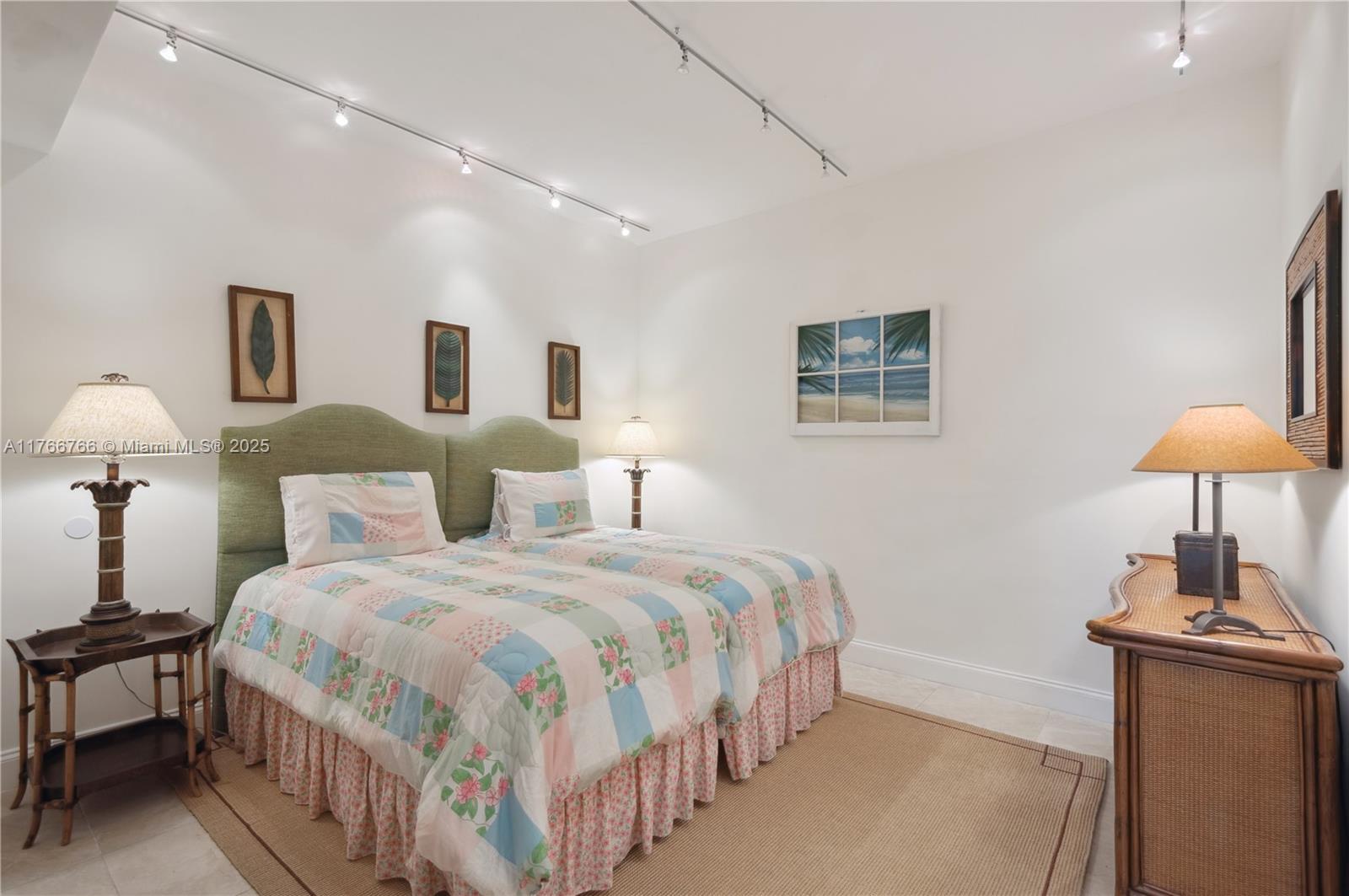 765 Crandon Boulevard, Unit 111 Key Biscayne, FL 33149 - Photo 16 of 57 a bedroom with bed and a lamp with the dresser