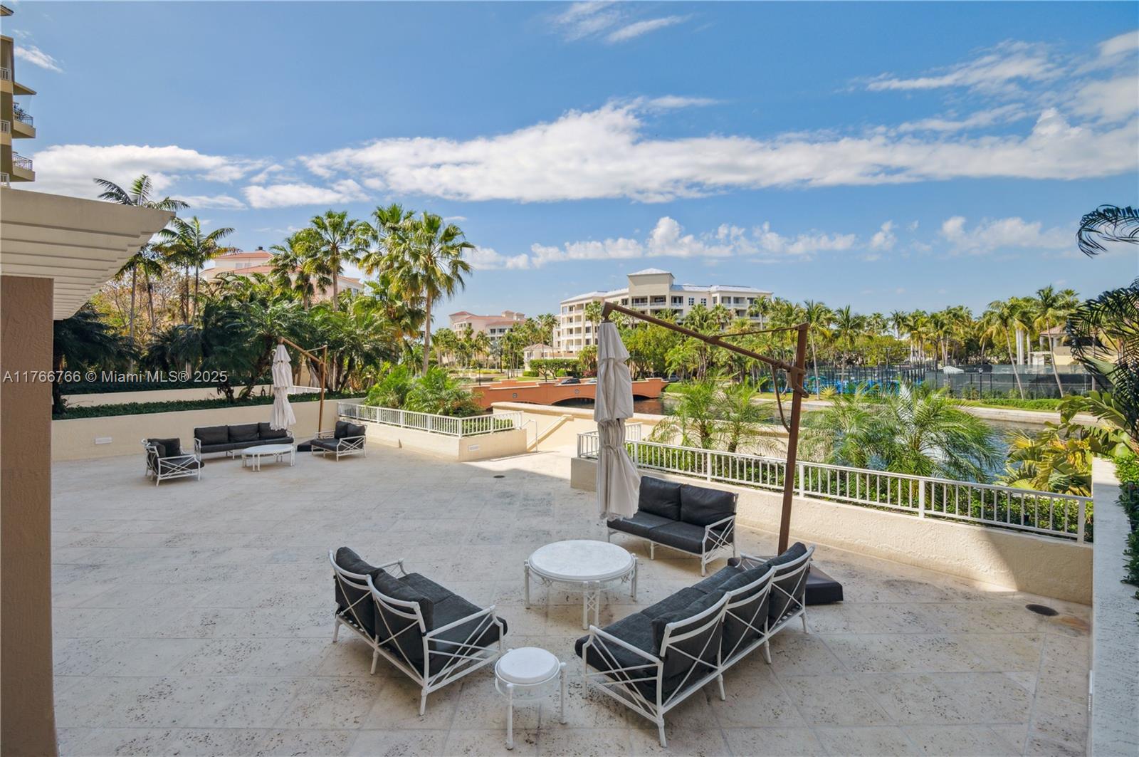 765 Crandon Boulevard, Unit 111 Key Biscayne, FL 33149 - Photo 21 of 57 a view of a swimming pool with a lounge chair