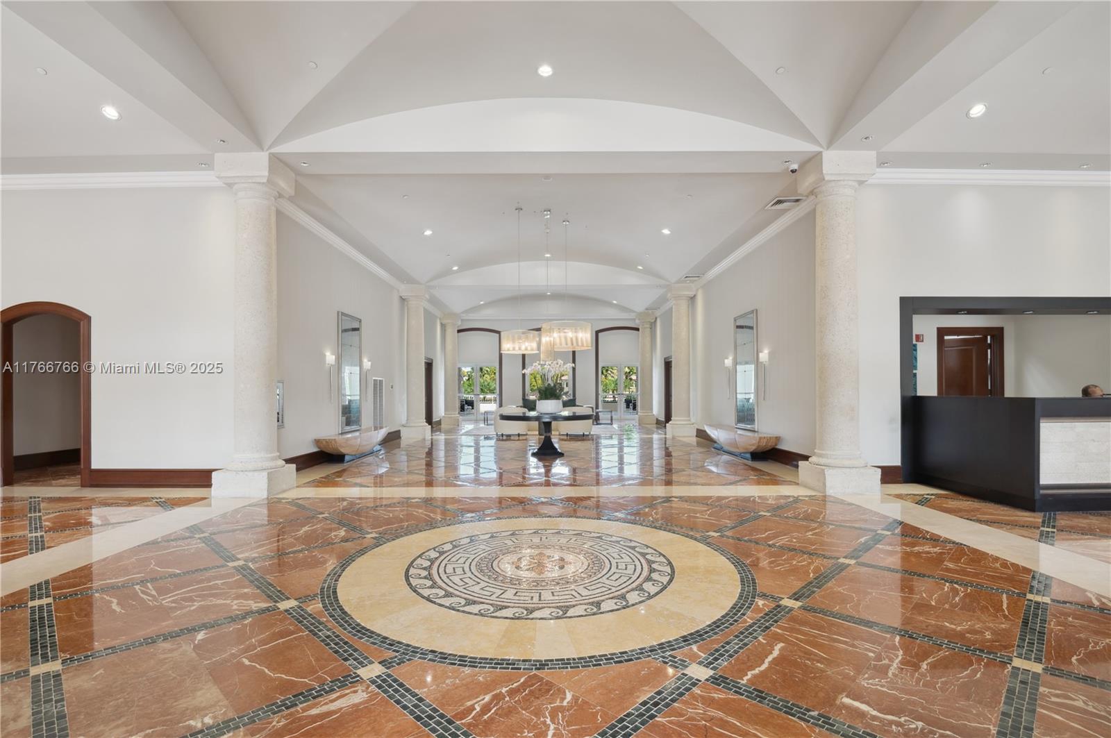 765 Crandon Boulevard, Unit 111 Key Biscayne, FL 33149 - Photo 23 of 57 a hall with dining table and chairs