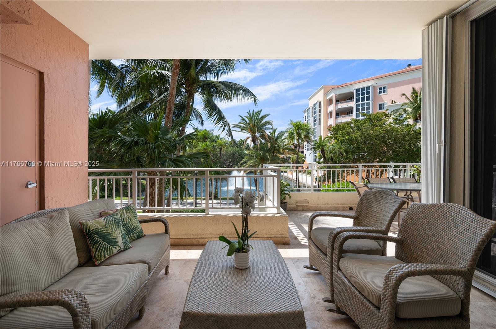 765 Crandon Boulevard, Unit 111 Key Biscayne, FL 33149 - Photo 3 of 57 a balcony with furniture and a potted plant