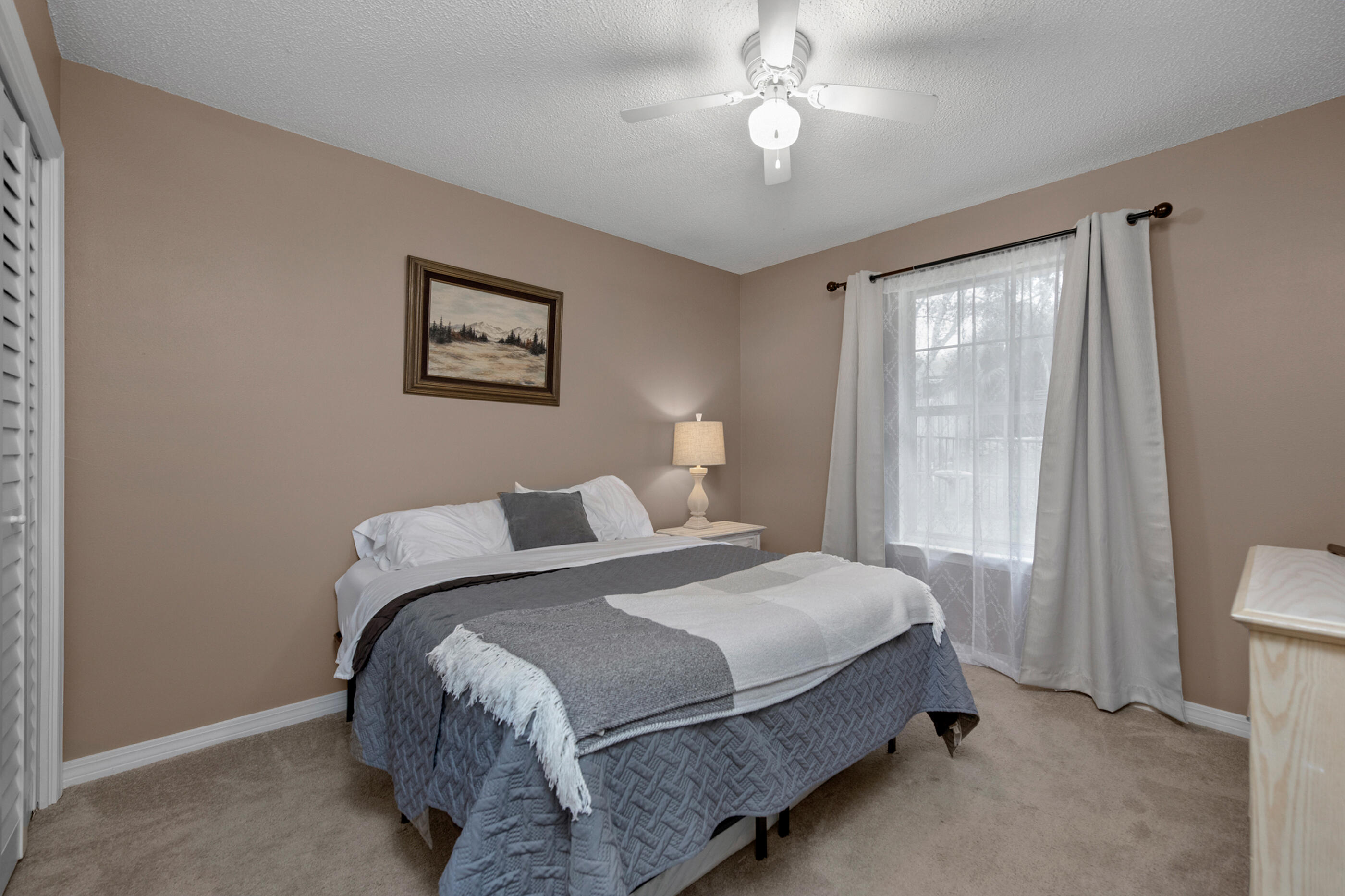 4439 Antioch Road Crestview, FL 32536 - Photo 12 of 32 a bedroom with a bed and a chandelier