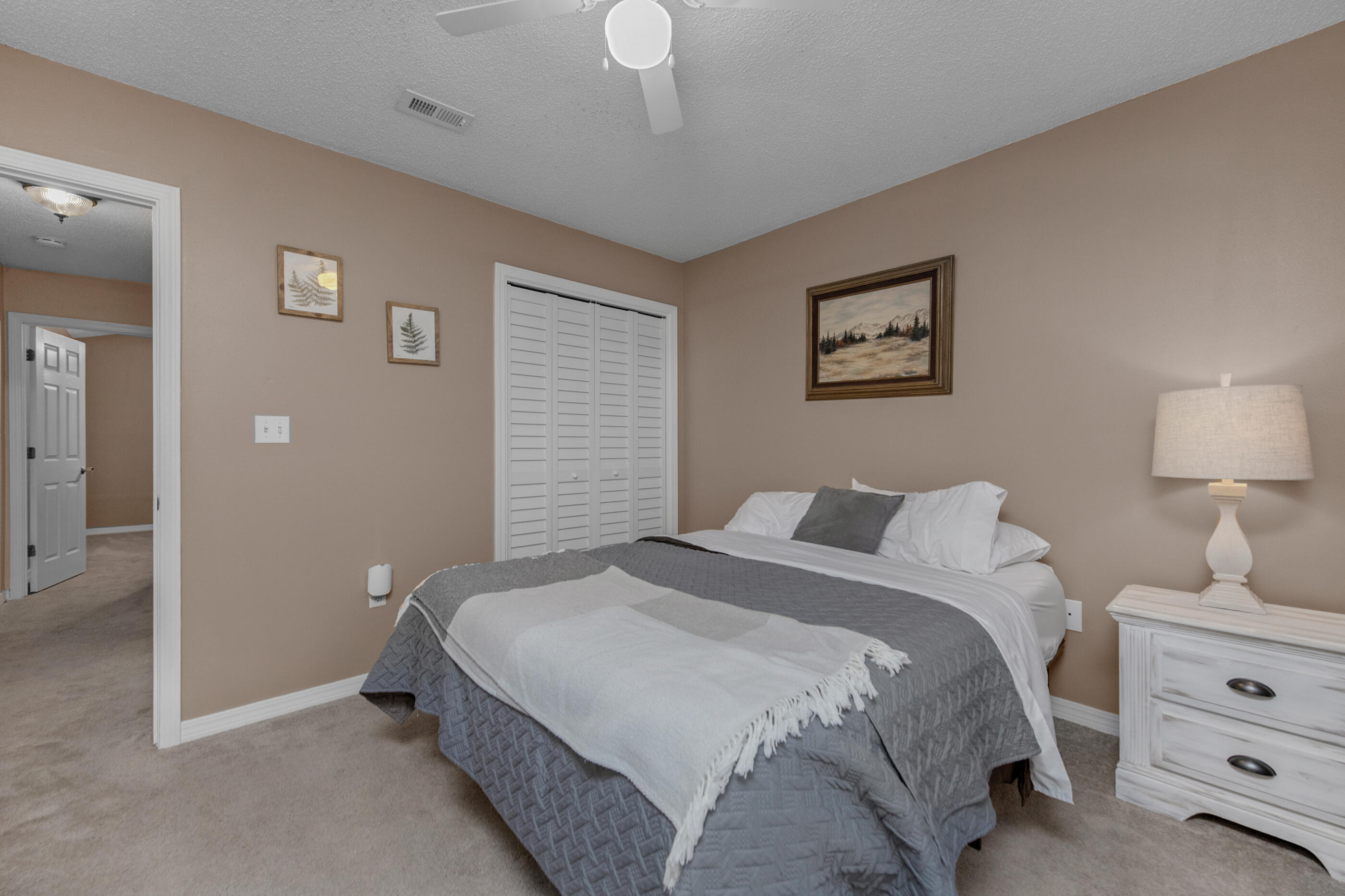 4439 Antioch Road Crestview, FL 32536 - Photo 13 of 32 a bedroom with a bed and a lamp on dresser