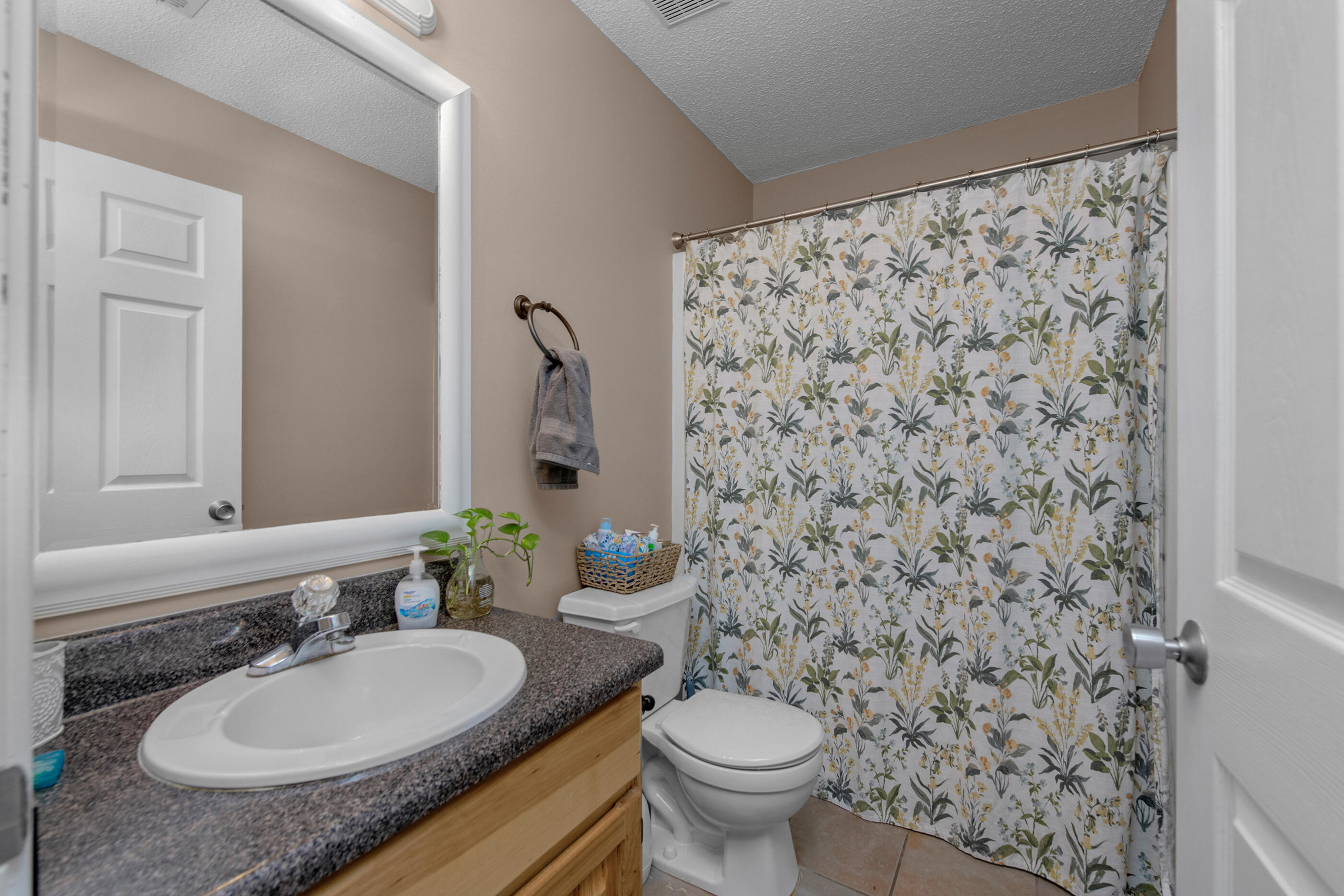4439 Antioch Road Crestview, FL 32536 - Photo 14 of 32 a bathroom with a granite countertop sink and a mirror