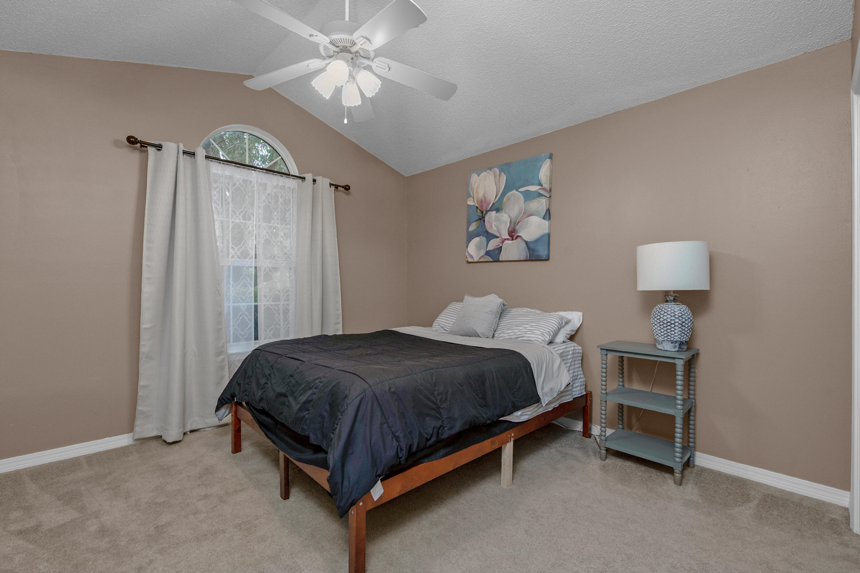4439 Antioch Road Crestview, FL 32536 - Photo 15 of 32 a bedroom with a bed and a chandelier