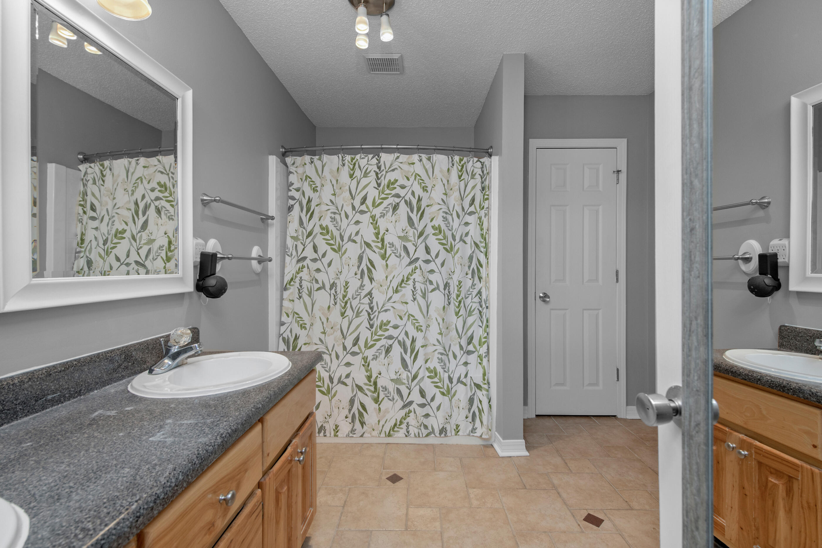 4439 Antioch Road Crestview, FL 32536 - Photo 18 of 32 a bathroom with a granite countertop sink and a mirror