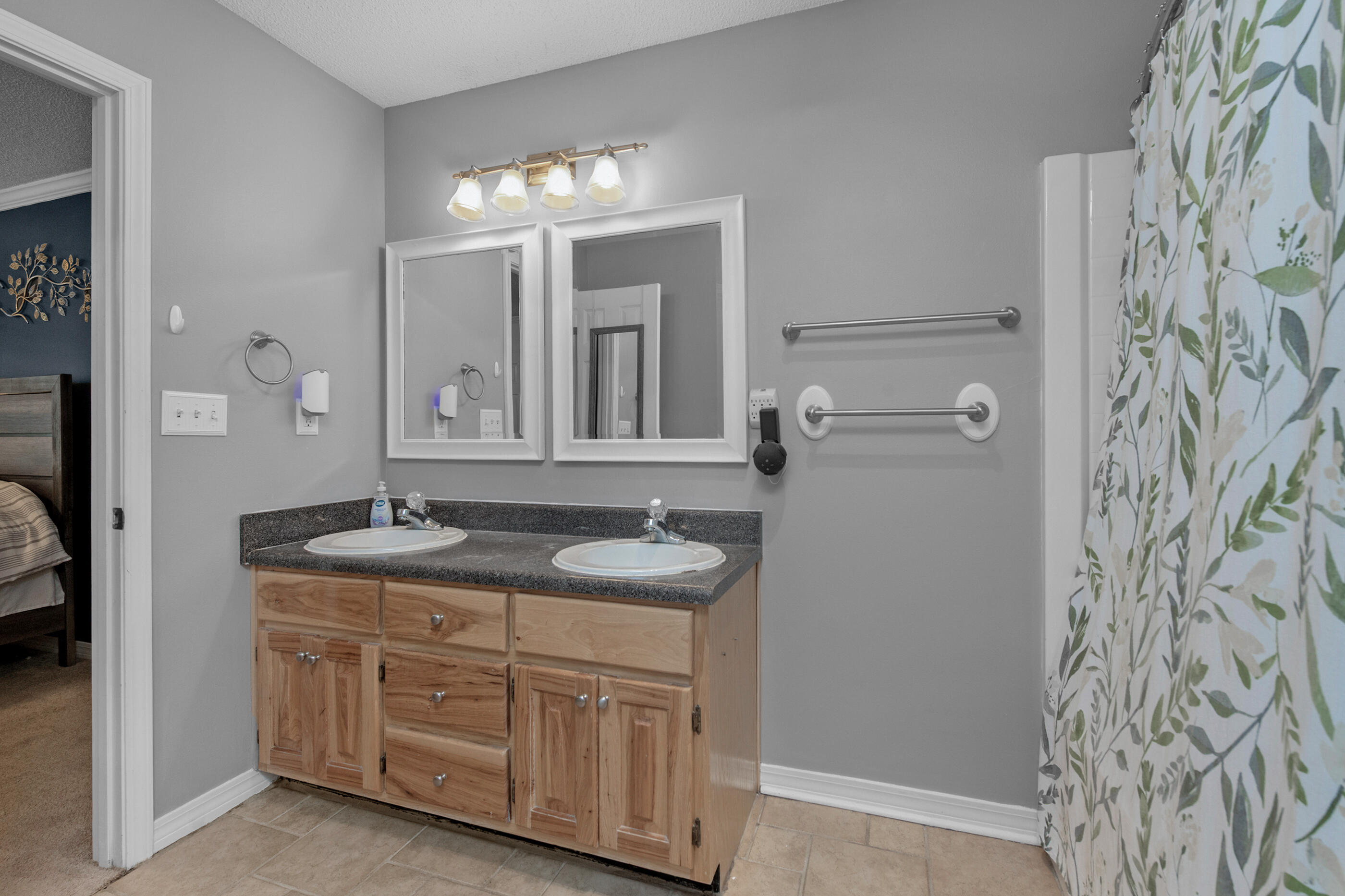4439 Antioch Road Crestview, FL 32536 - Photo 19 of 32 a bathroom with double vanity and a mirror