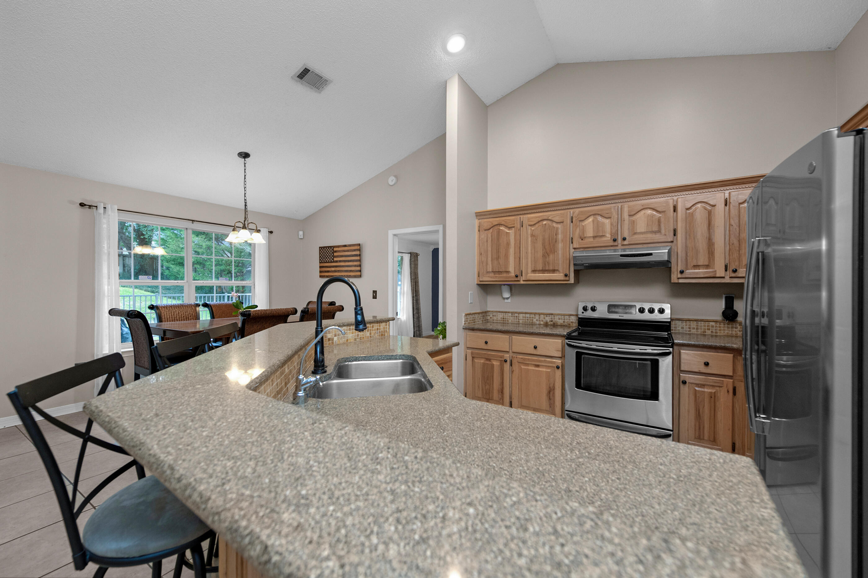 4439 Antioch Road Crestview, FL 32536 - Photo 5 of 32 a kitchen with stainless steel appliances granite countertop a sink stove and refrigerator