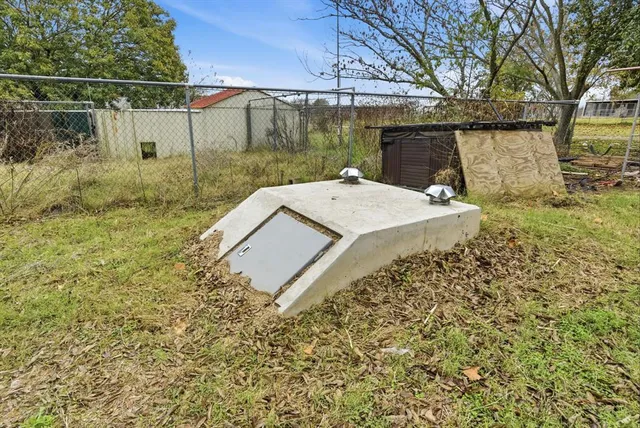 a backyard of a house with table and chairs
