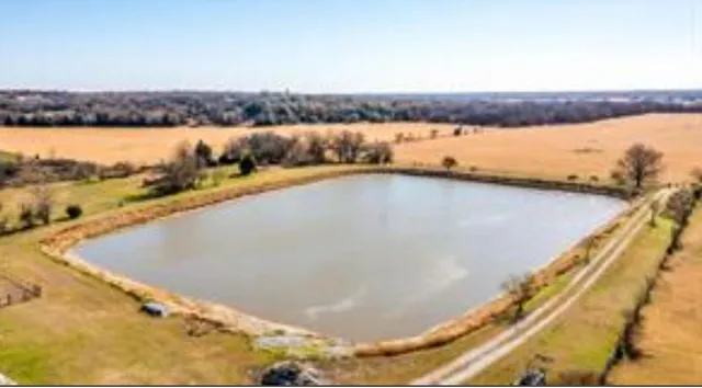 a view of swimming pool with trees in the background