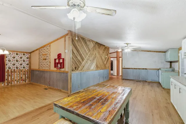 a view of a kitchen with wooden floor and a window