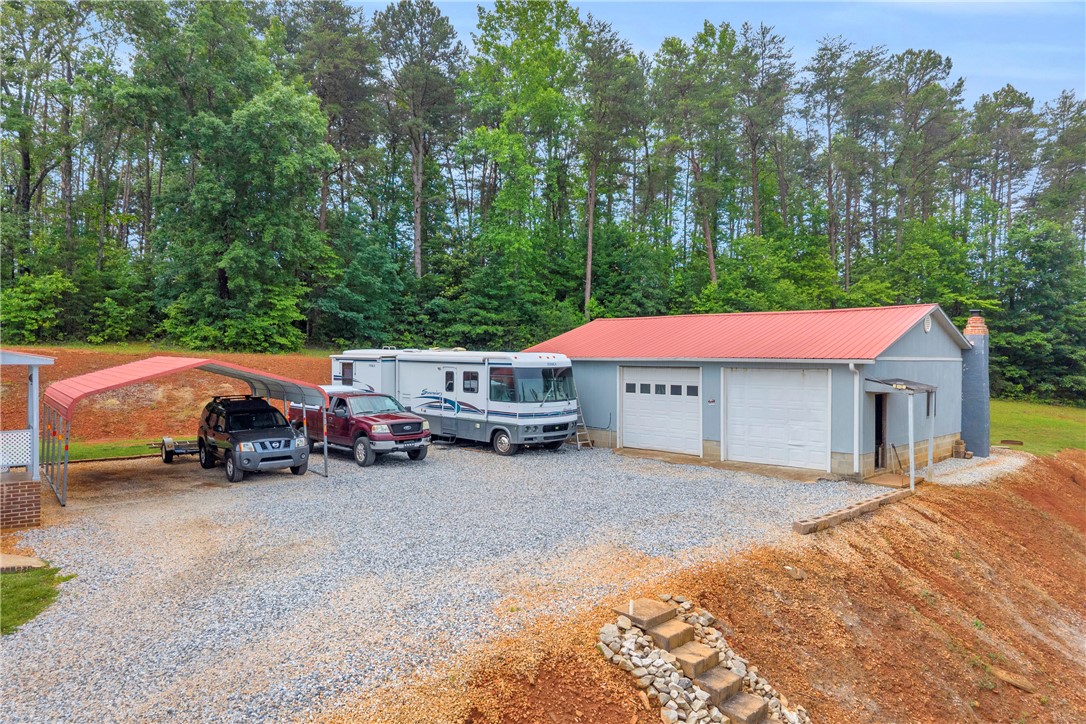 721 Cedar Crest Trail Walhalla, SC 29691 - Photo 32 of 47 A spacious gravel lot provides ample parking and easy access to the garage and detached carport.