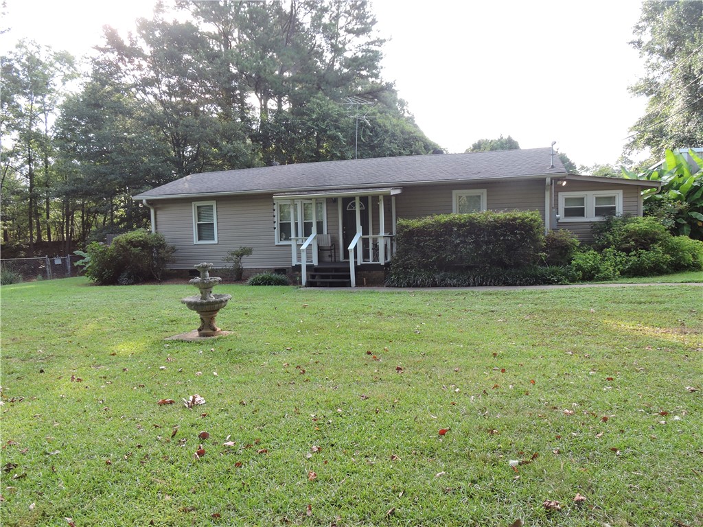 1901 Hattons Ford Road Townville, SC 29689 - Photo 2 of 33 A classic ranch home nestled among mature trees offers serene living.