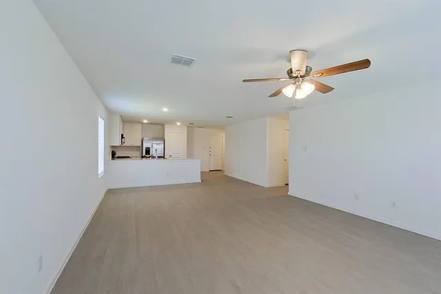 a view of a kitchen with a sink and a chandelier fan