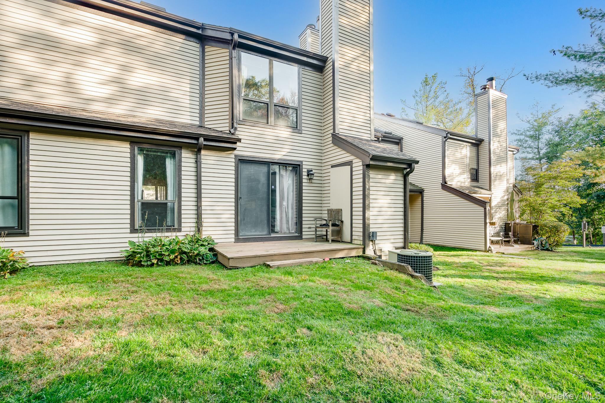 113 Antler Ridge, Unit 113 Ossining, NY 10562 - Photo 22 of 26 a front view of a house with a yard and garage