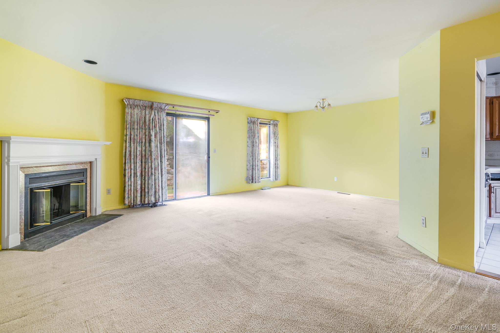 113 Antler Ridge, Unit 113 Ossining, NY 10562 - Photo 4 of 26 a view of livingroom with fireplace and window