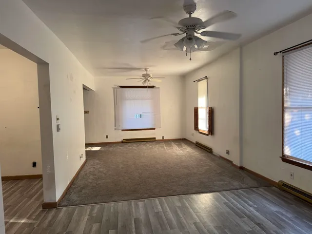 wooden floor in a hall with a window