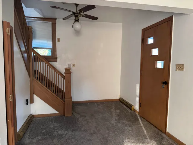 a white toilet sitting next to a shower curtain
