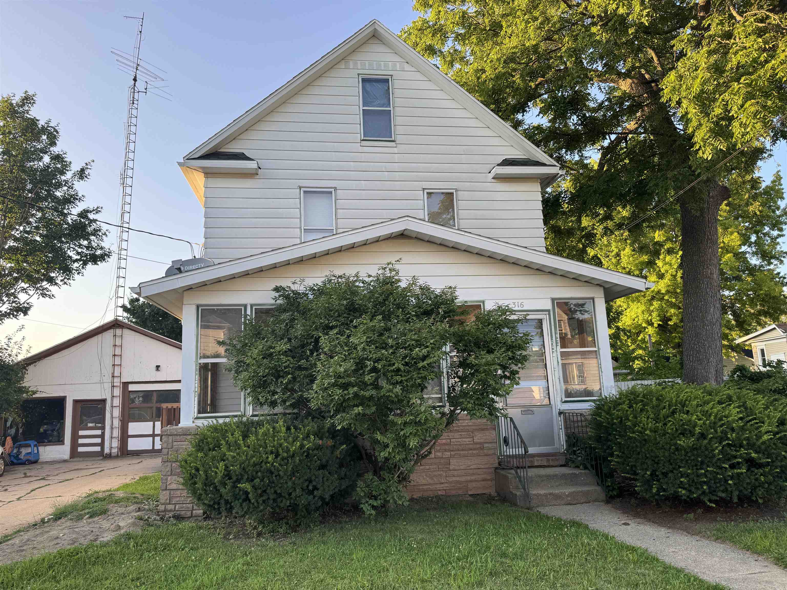 316 West American Street Freeport, IL 61032 - Photo 2 of 18 a view of a house with a yard plants and large tree