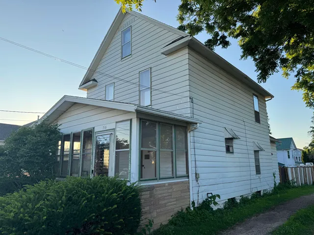a front view of a house with garage