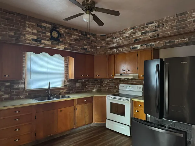 a kitchen with a refrigerator and a sink