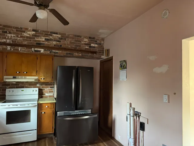 a kitchen with a refrigerator and stove