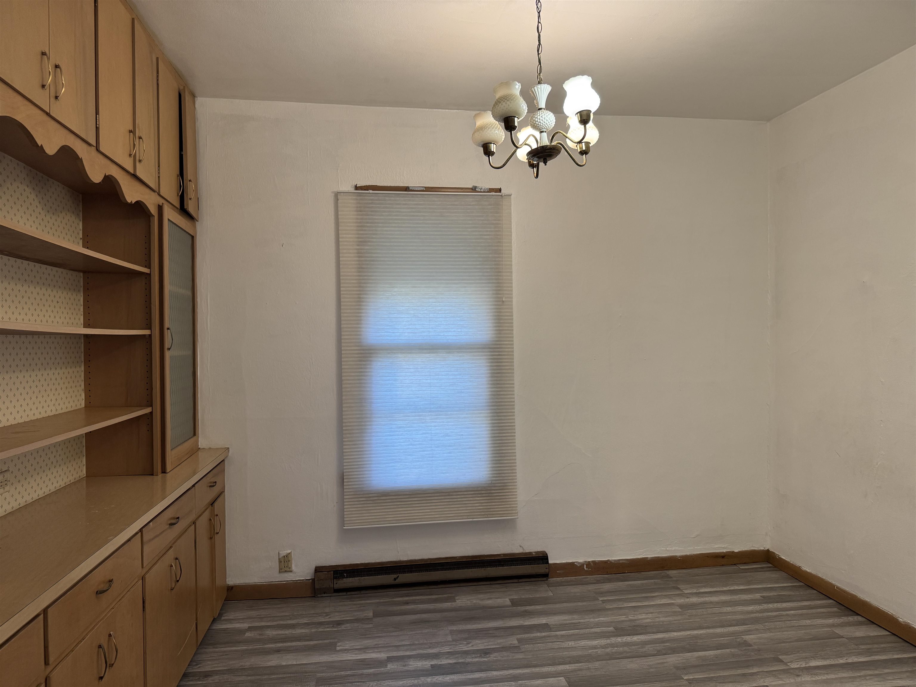 316 West American Street Freeport, IL 61032 - Photo 9 of 18 a view of a room with wooden floor and chandelier