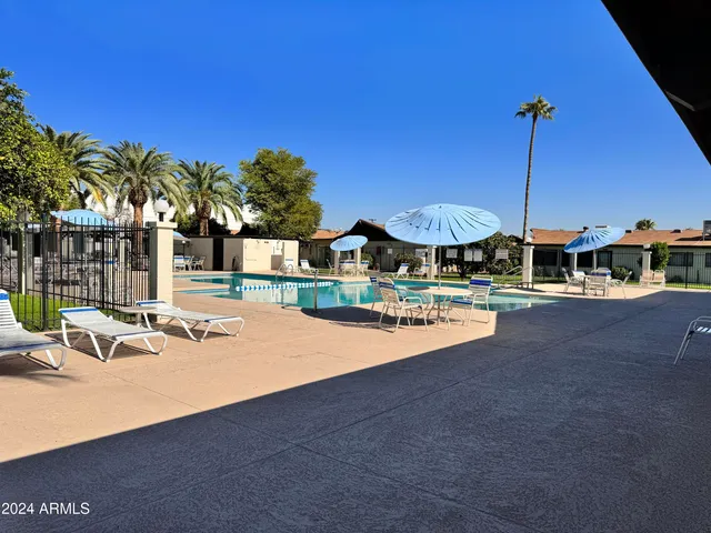 a view of a swimming pool with a table and chairs