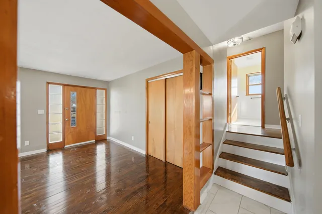a view of an entryway with wooden floor and door