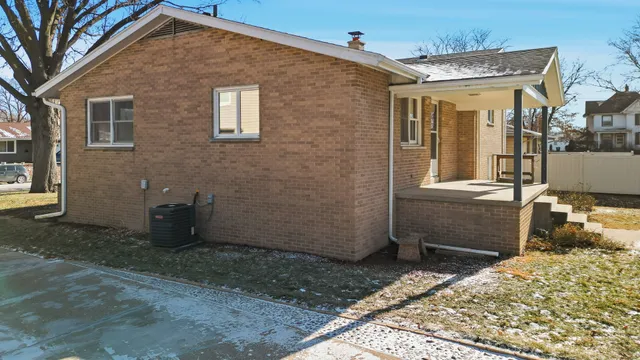 a view of a house with snow on the road