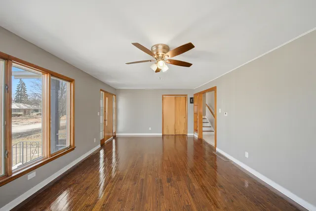 wooden floor in an empty room with a window
