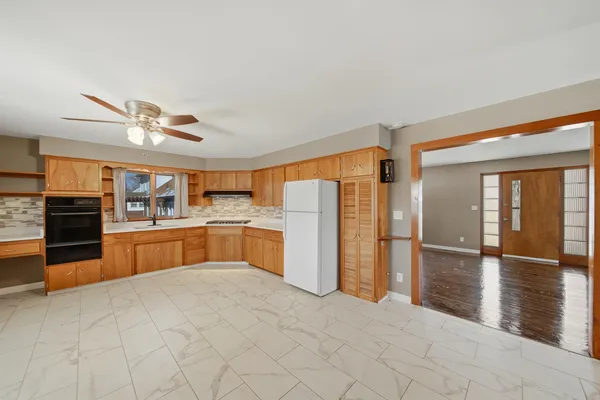 a kitchen with stainless steel appliances granite countertop a refrigerator and a sink