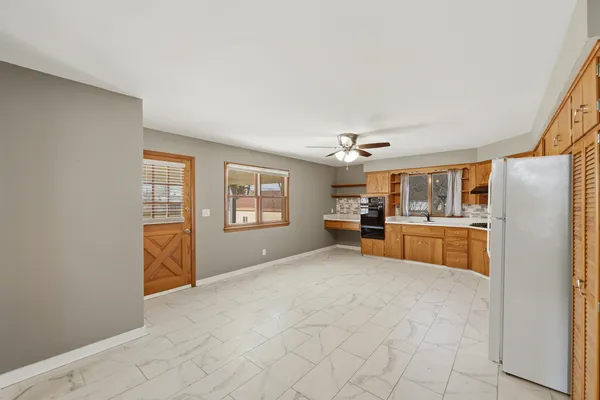 a view of a kitchen with furniture and windows