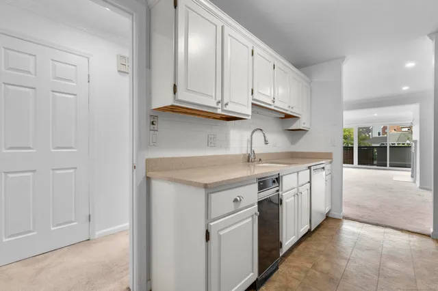 a kitchen with stainless steel appliances granite countertop a stove and a sink