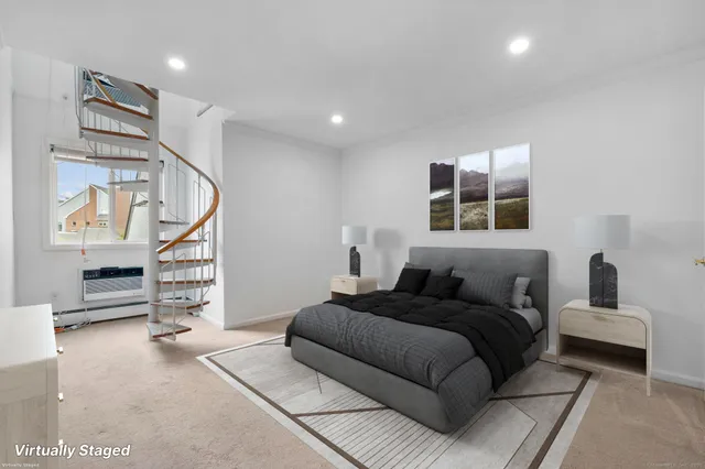 a bedroom with furniture and a window