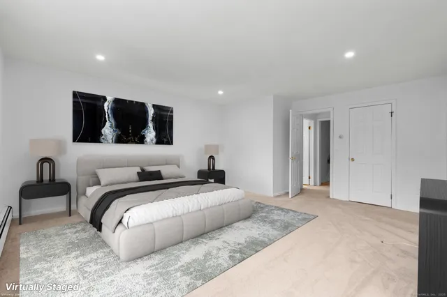 a spacious bedroom with a bed and a couch