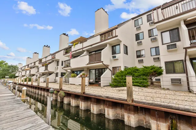a view of building with river and small yard