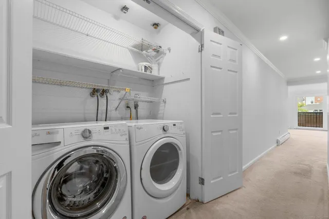a view of a hallway with washer and dryer