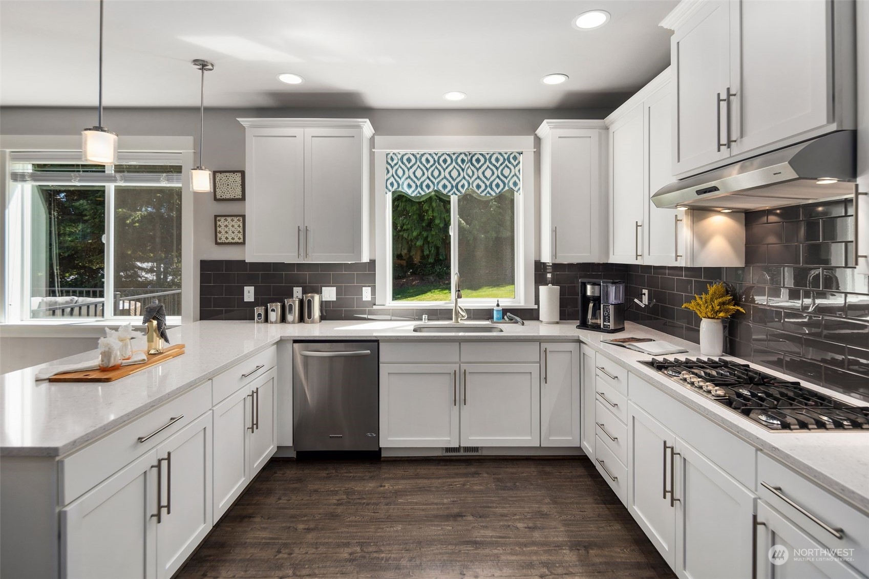 22817 Barker Road Bothell, WA 98021 - Photo 11 of 40 a large white kitchen with stainless steel appliances granite countertop a stove a sink and a microwave