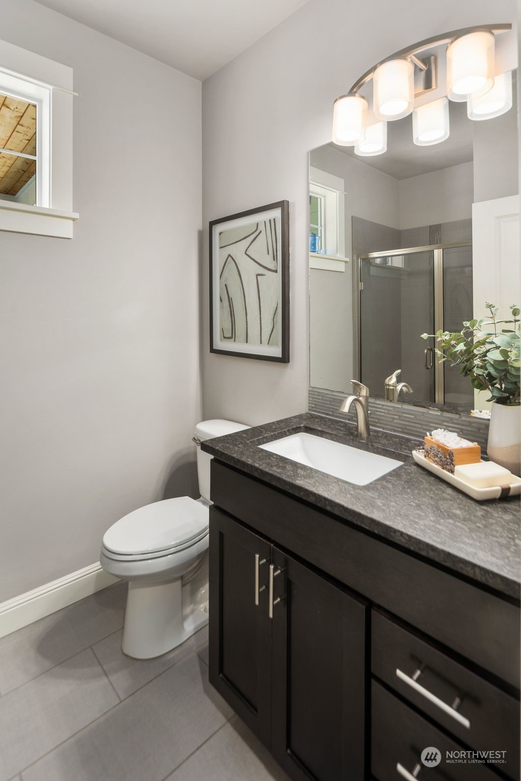 22817 Barker Road Bothell, WA 98021 - Photo 22 of 40 a bathroom with a granite countertop sink a toilet and a mirror
