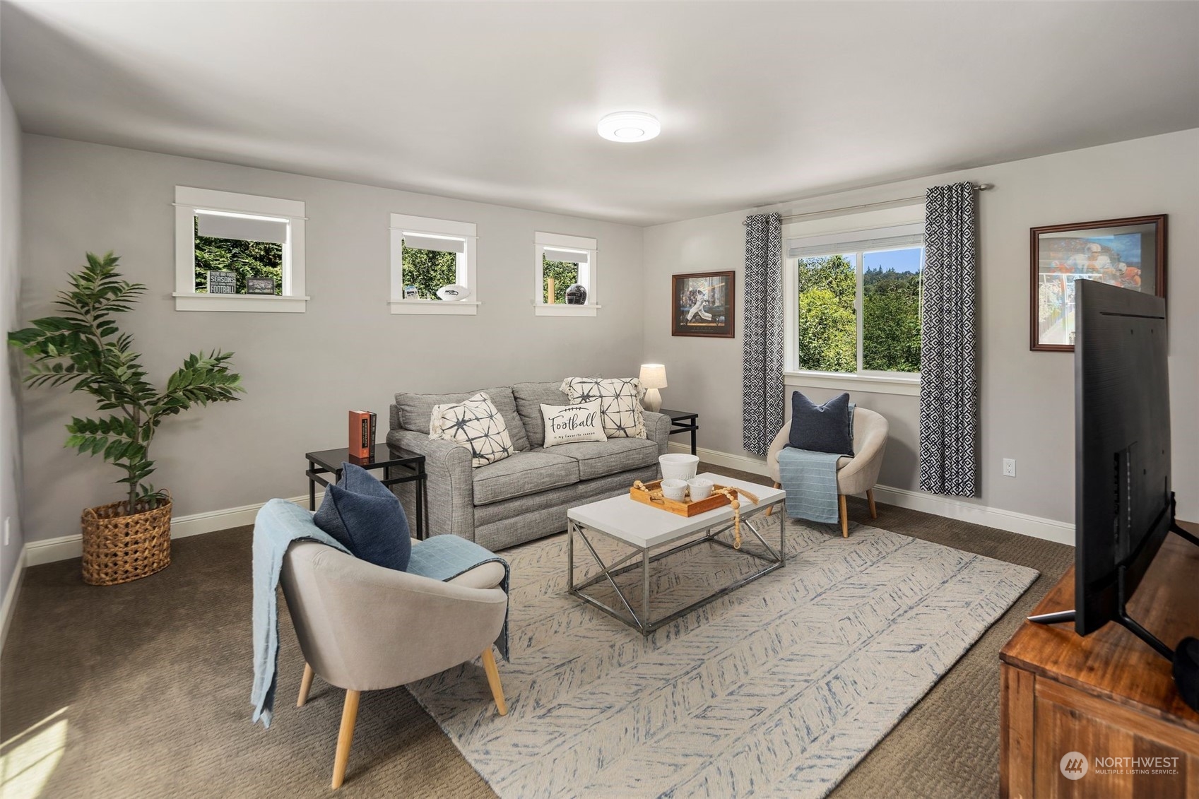 22817 Barker Road Bothell, WA 98021 - Photo 29 of 40 a living room with furniture and a flat screen tv