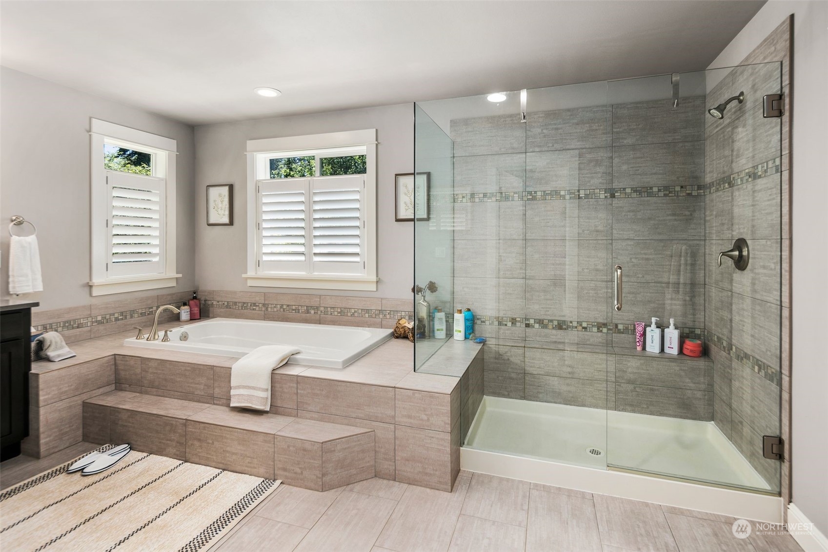 22817 Barker Road Bothell, WA 98021 - Photo 33 of 40 a spacious bathroom with a bathtub a sink a mirror and a shower