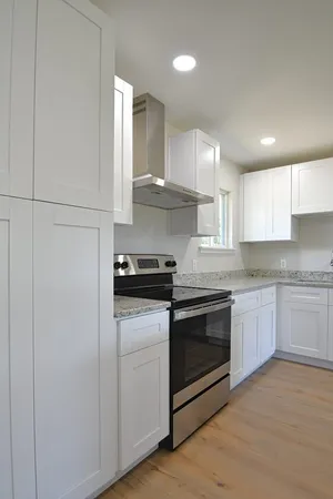 a kitchen with stainless steel appliances granite countertop a stove a sink and a refrigerator