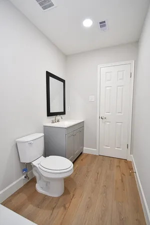 a bathroom with a toilet a sink and mirror