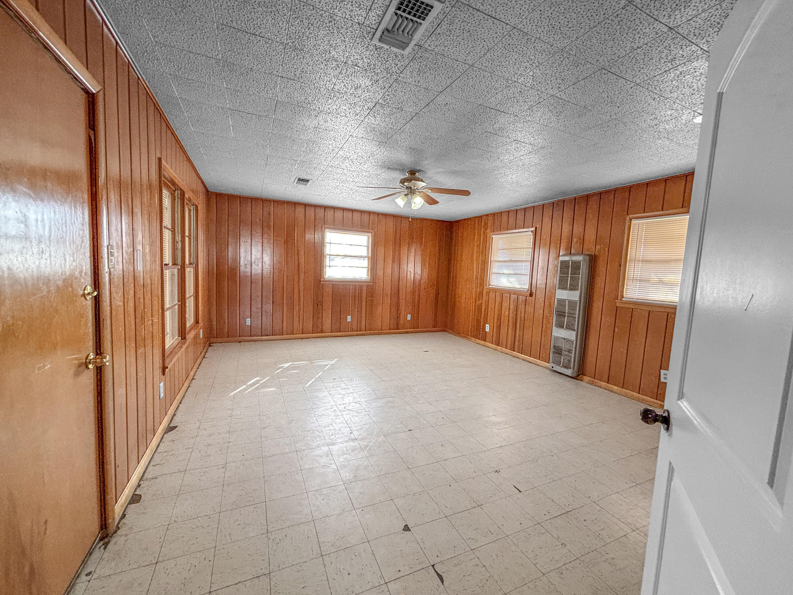 4411 45th Street Lubbock, TX 79414 - Photo 17 of 44 an empty room with windows and chandelier fan
