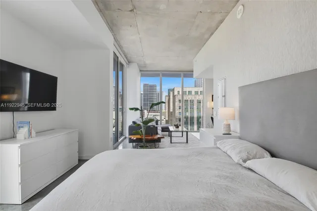 a view of living room kitchen with furniture and a flat screen tv