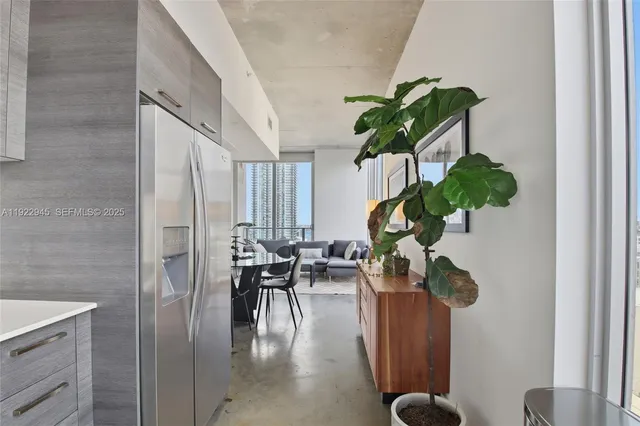 a view of living room with furniture and a potted plant