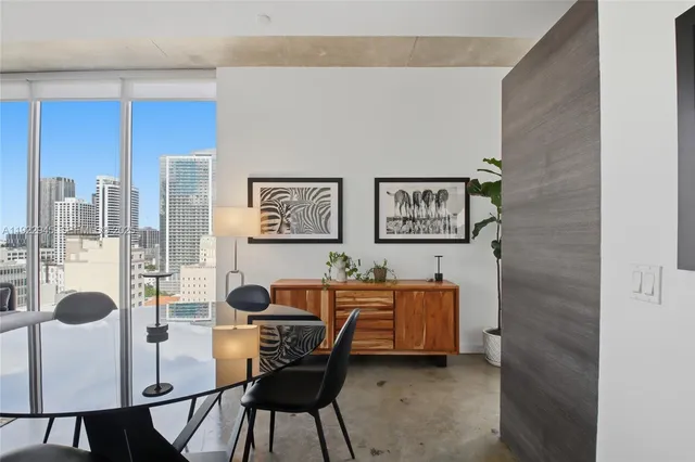 a workspace with furniture and a large window